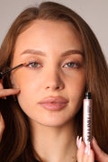 front view of model applying the no limit eyelash serum 